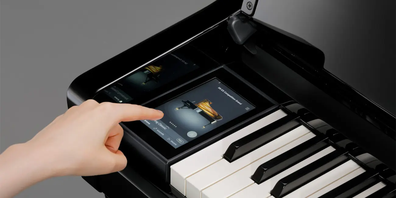 Kawai CA 901 touch display being operated by hand