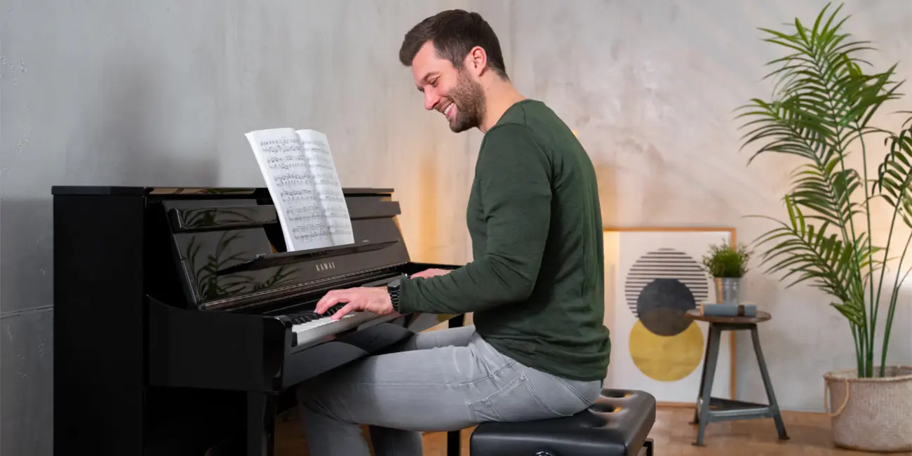 Kawai CA901 digital piano being played by a man in a living room