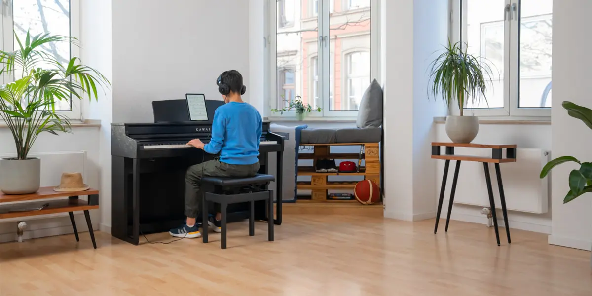 Person playing a Kawai CA 401 digital piano in a bright living room