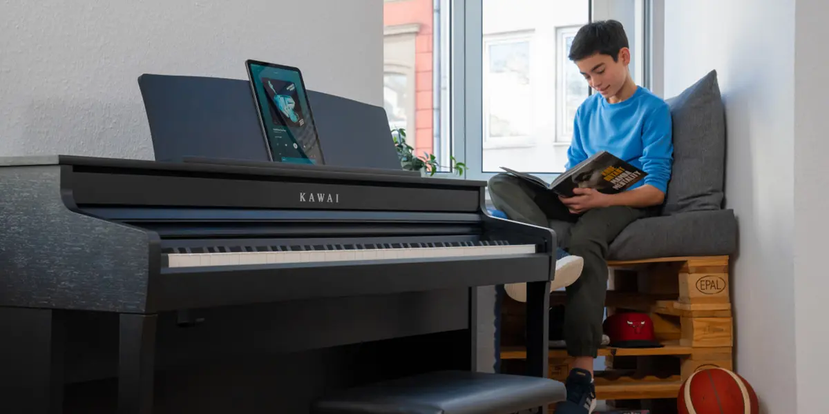 Kawai CA 401 digital piano with a person playing and the music desk open
