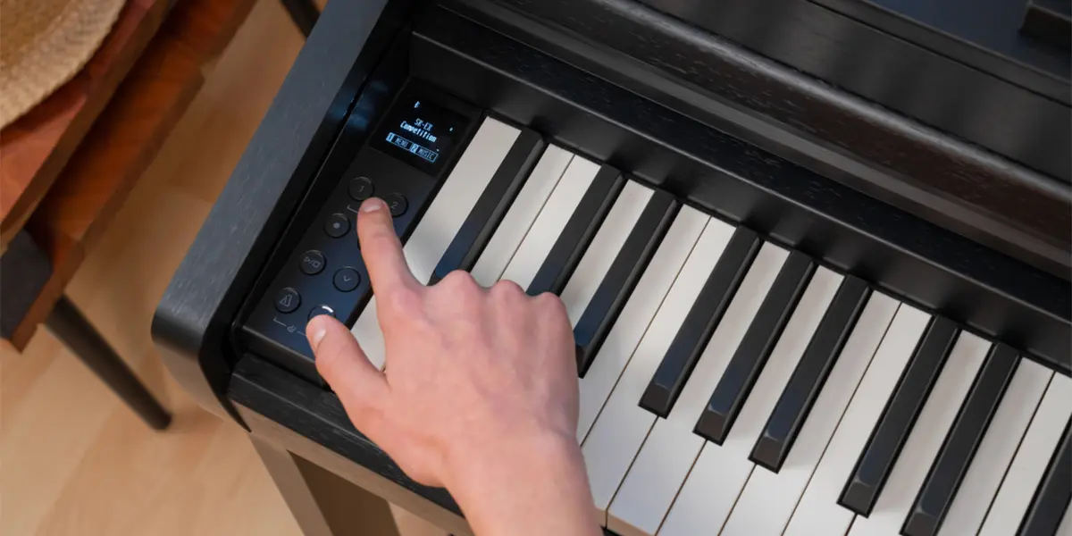 Kawai CA 401 control panel being operated by hand