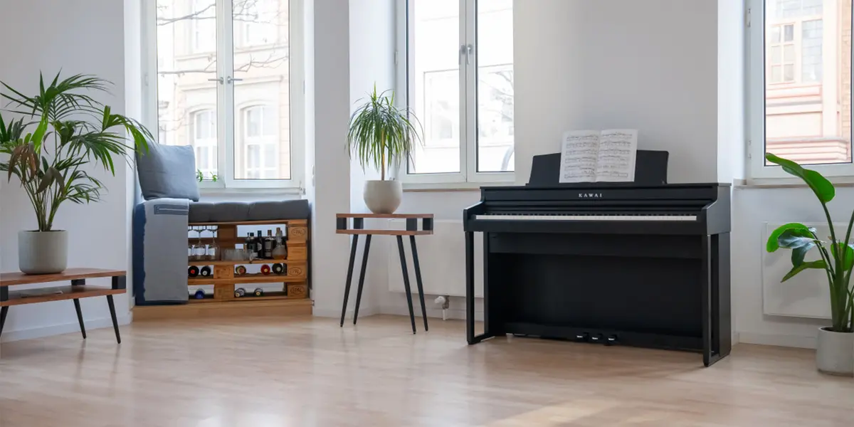 Kawai CA 401 digital piano in black with sheet music in a bright living room