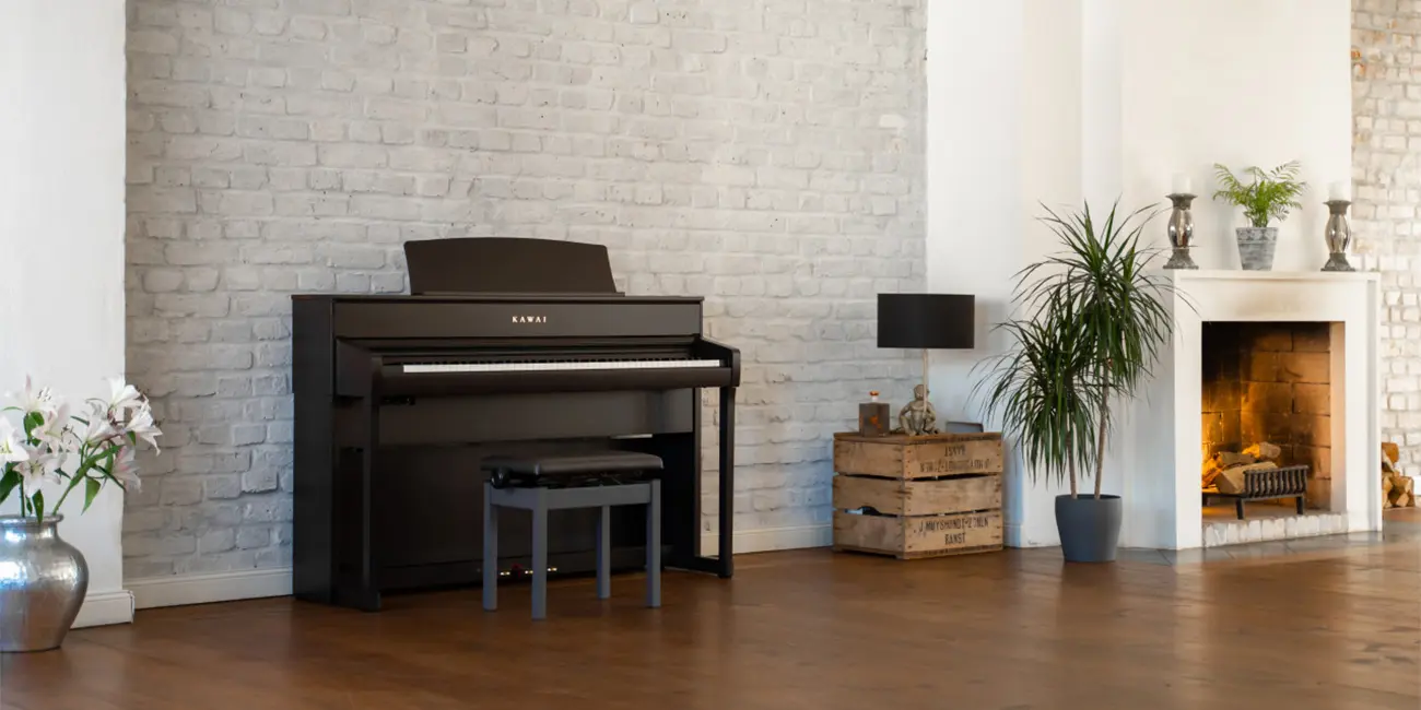 Kawai CA 701 digital piano in front of a fireplace in the living room