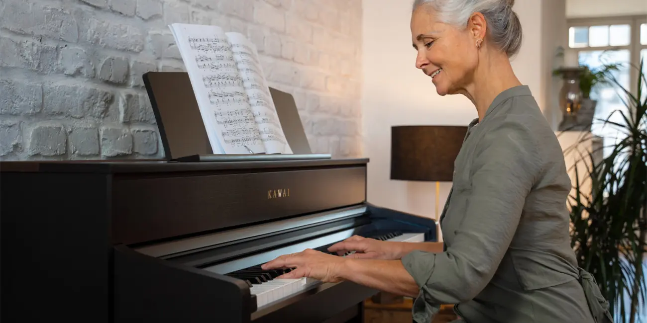 Woman playing a Kawai CA701 digital piano