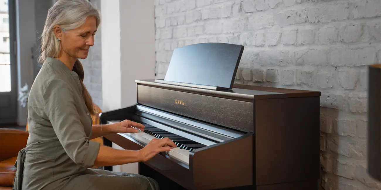 Kawai CA 701 digital piano in dark wood finish being played