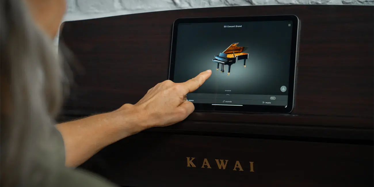 Kawai CA 701 touch display being operated by hand