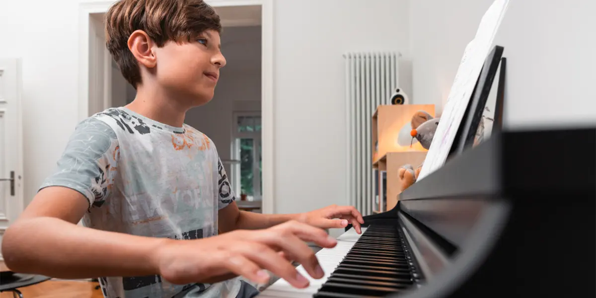 Kawai CX202 Digitalpiano in Schwarz wird von einem Jungen gespielt