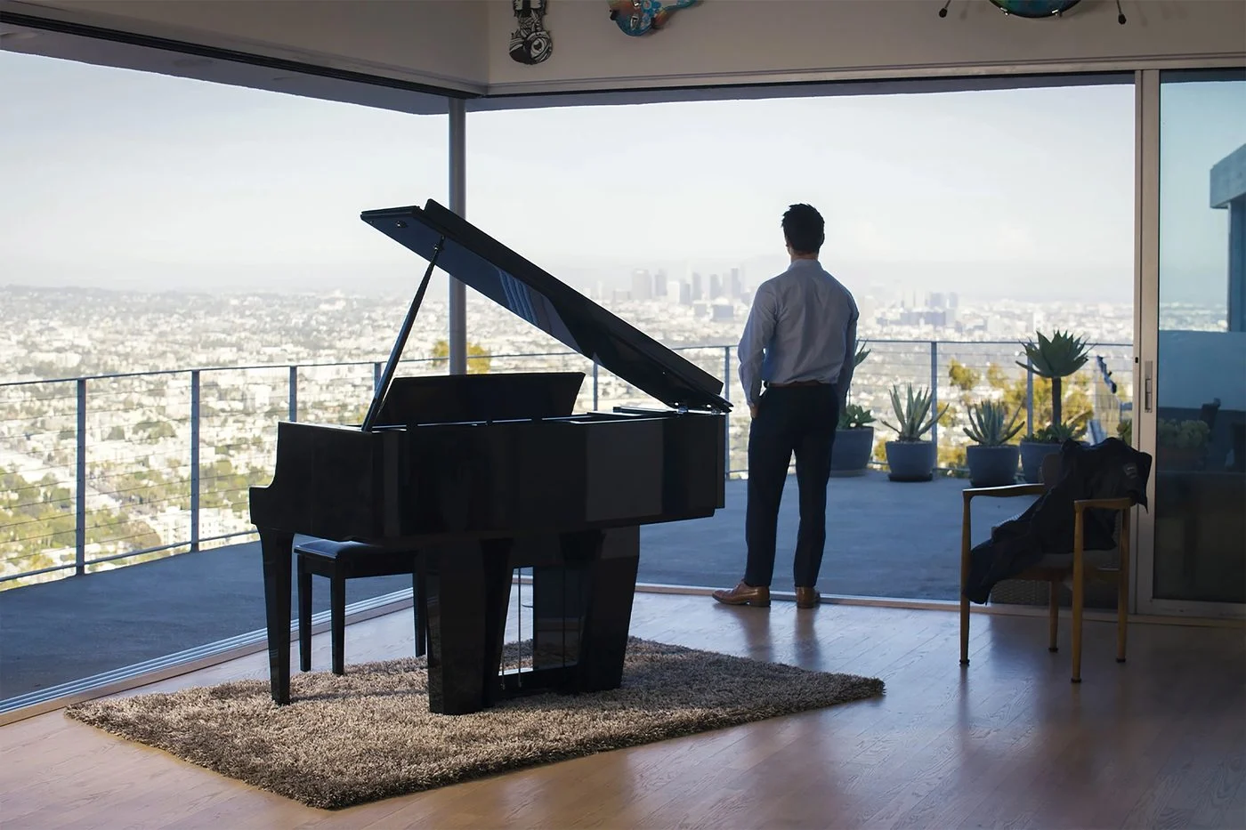 A Kawai NOVUS NV12 in a living room with a panoramic city view