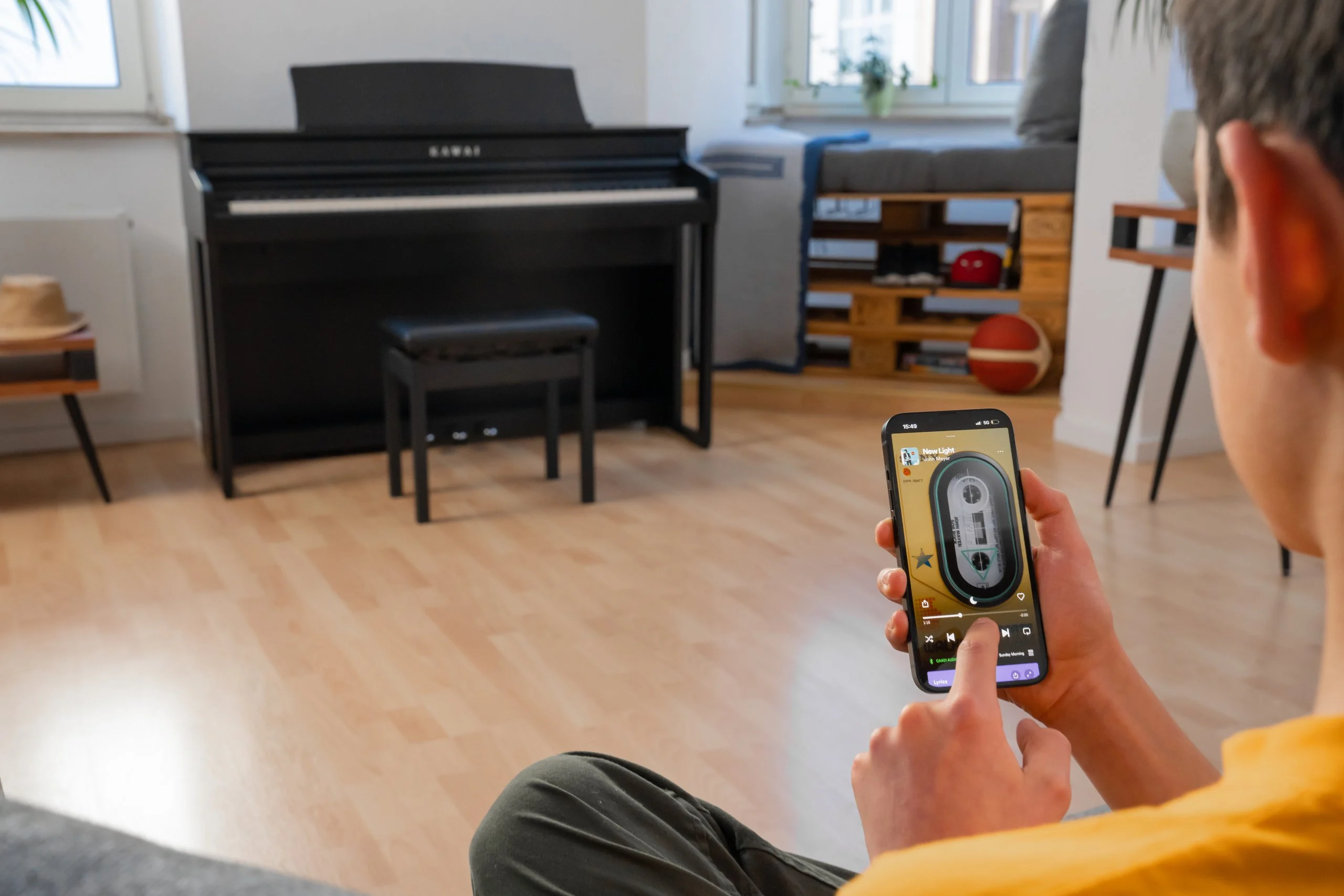 Young man controlling the Kawai CA 401 from his phone